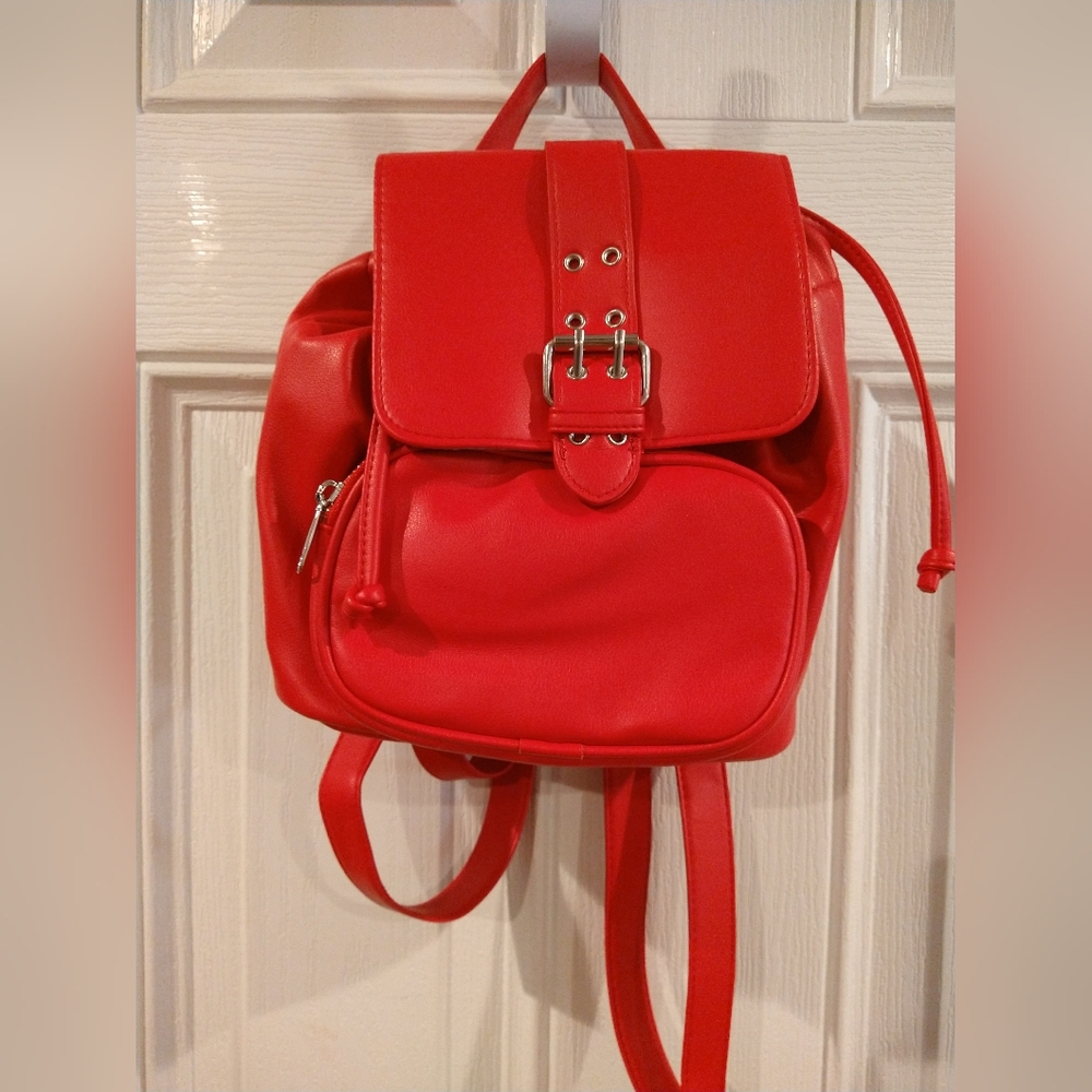 Mini backpack..Roomy. soft faux leather with pockets, drawstring , snap closure